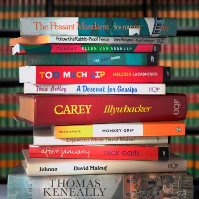 A stack of around a dozen Australian novels, with their spines showing.